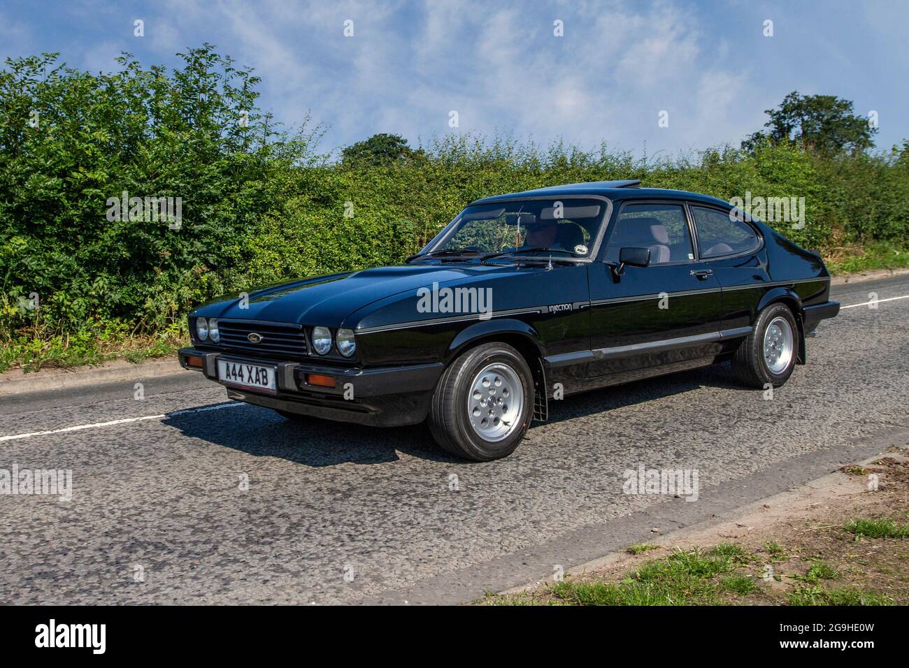 1983 80s eighties black British Ford Capri injection 2792cc petrol 4dr en-route to Capesthorne Hall classic July car show, Cheshire, UK Stock Photo