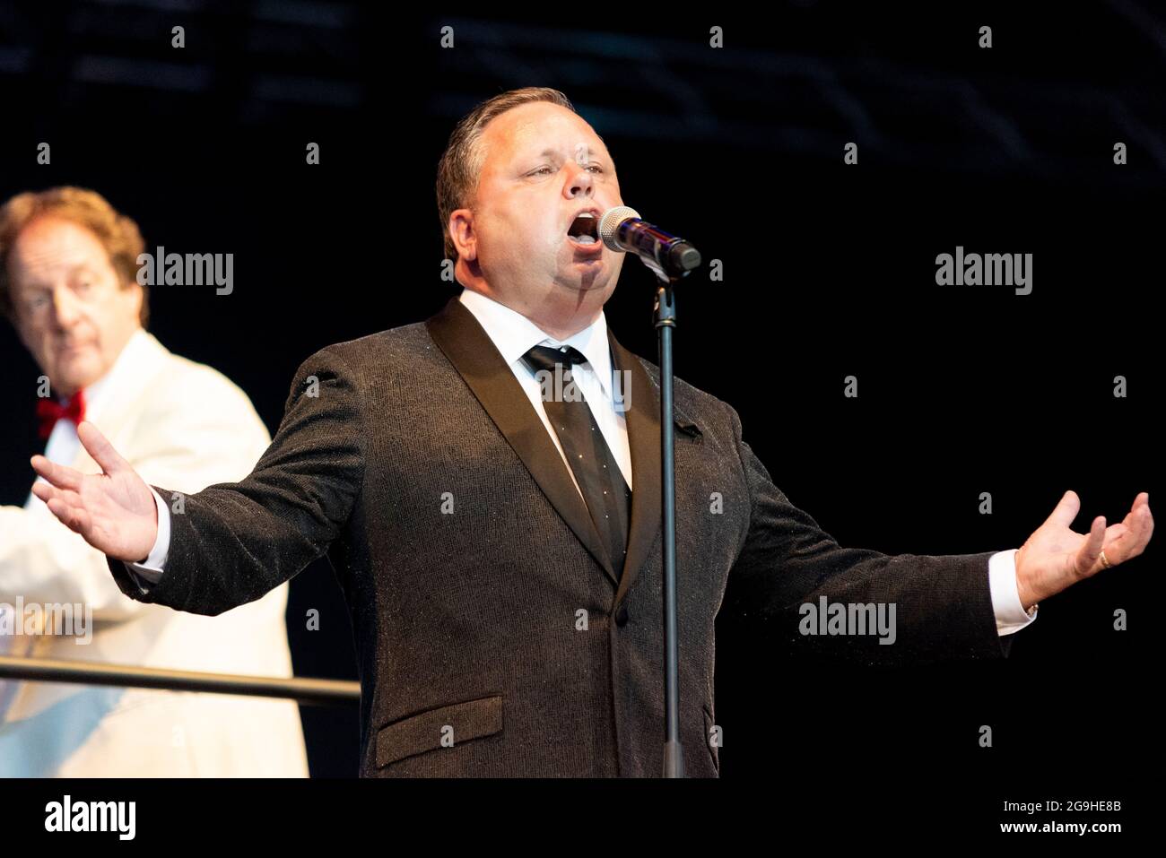 Paul Potts performing on stage in Maldon, Essex, UK. Welsh male operatic tenor singer, singing with the London Concert Orchestra after COVID lockdown Stock Photo
