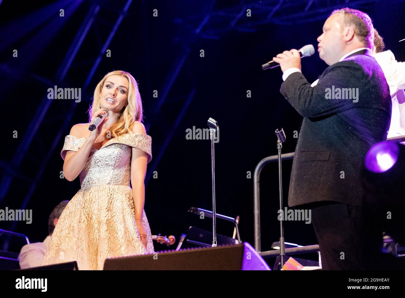 Paul Potts performing on stage in Maldon, Essex, UK with Katherine Jenkins. Welsh male operatic singer singing with the London Concert Orchestra Stock Photo