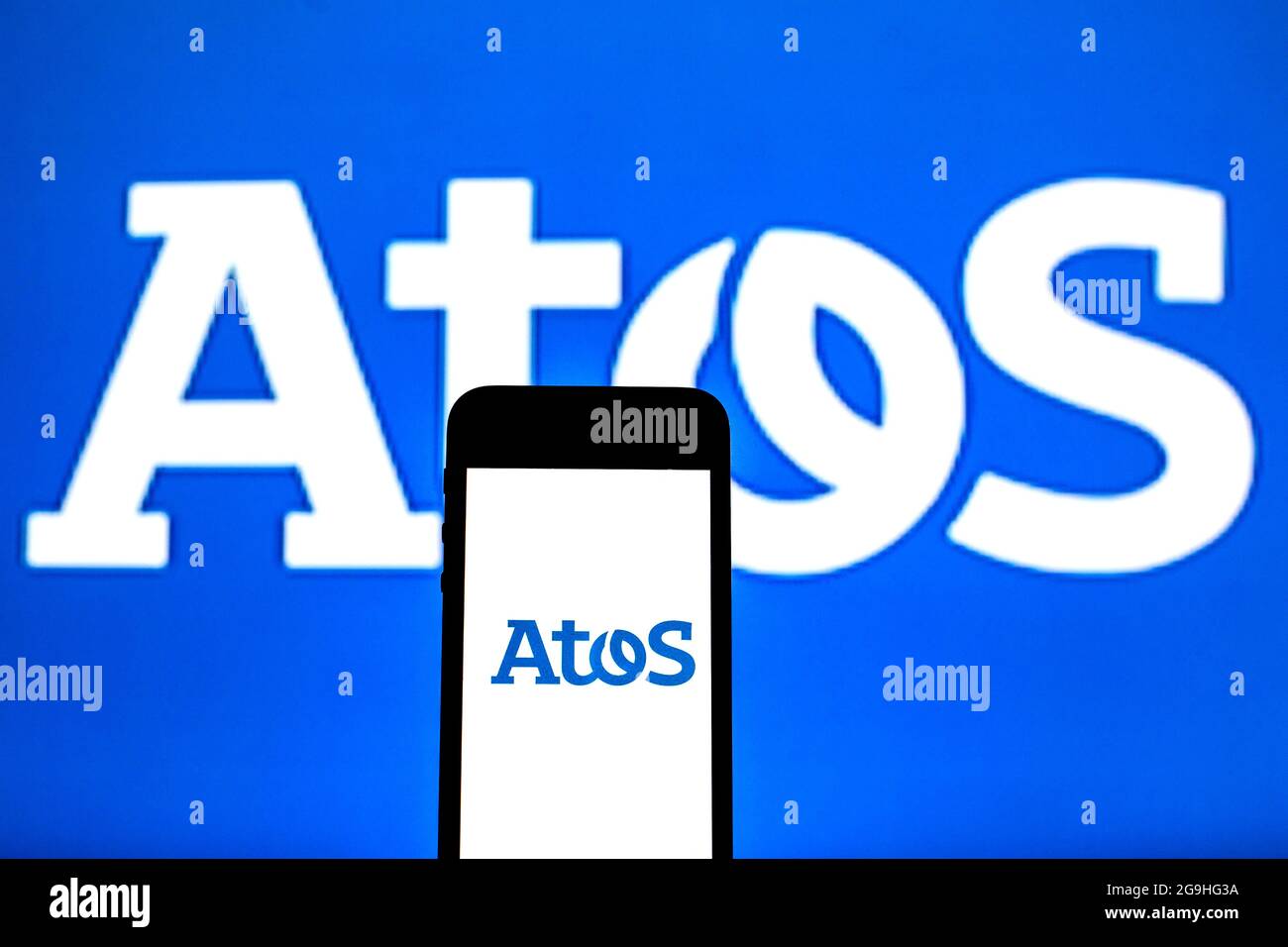 In this photo illustration an Atos logo seen displayed on a smartphone ...