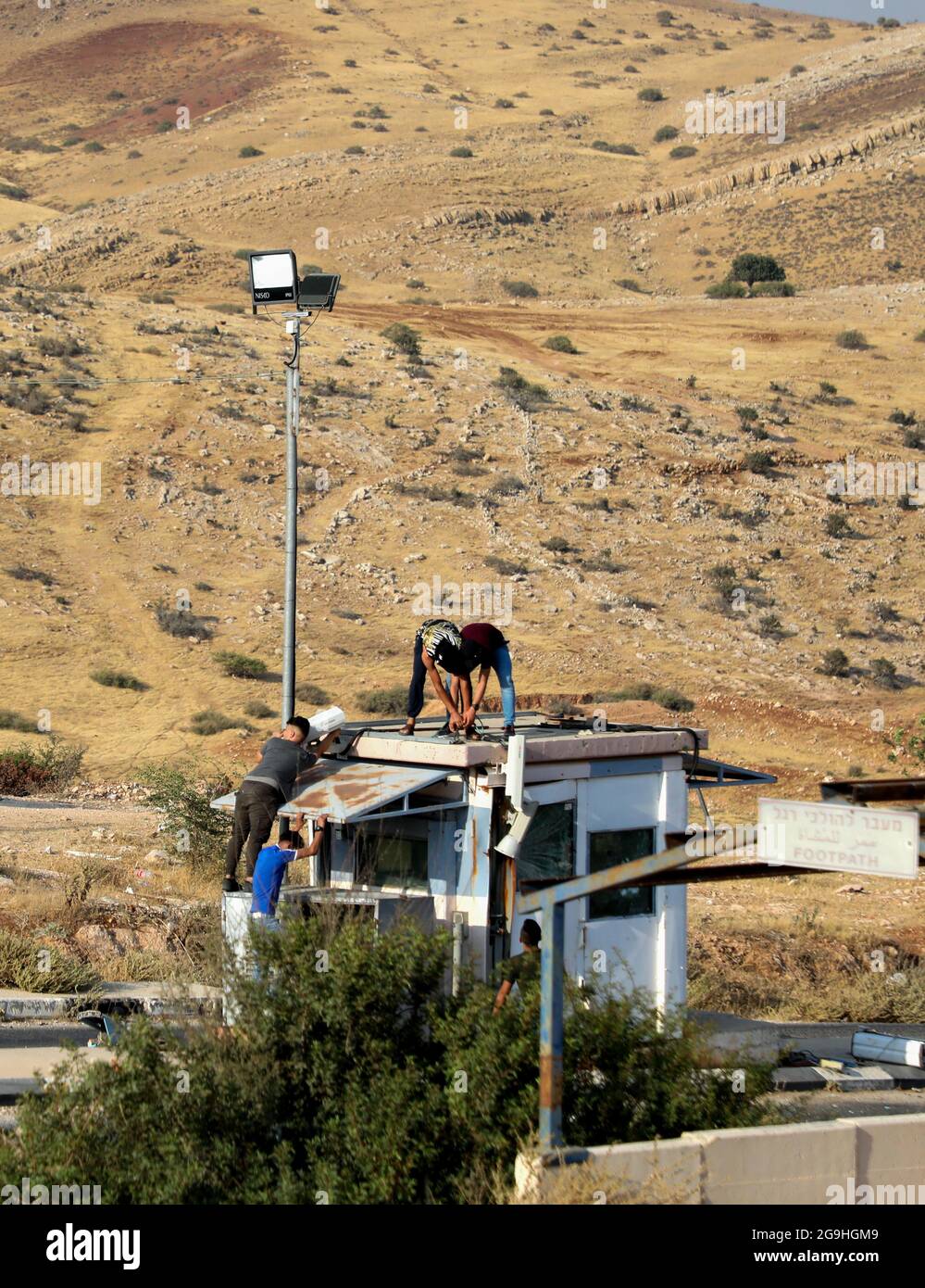July 24, 2021, Tubas, West Bank, Palestine: Tubas, West Bank Palestine.  Palestine. 24 July 2021. Palestinian youths begin to dismantle an abandoned  Israeli army base near the Tayasir checkpoint on the east
