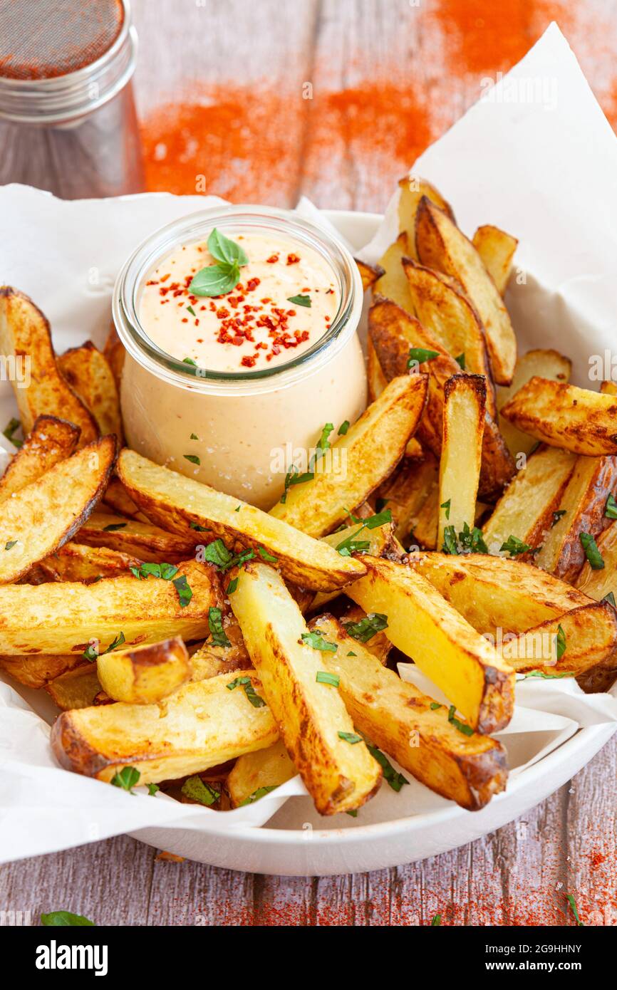 Homemade French fries, potato weddges with garlic dip Stock Photo Alamy