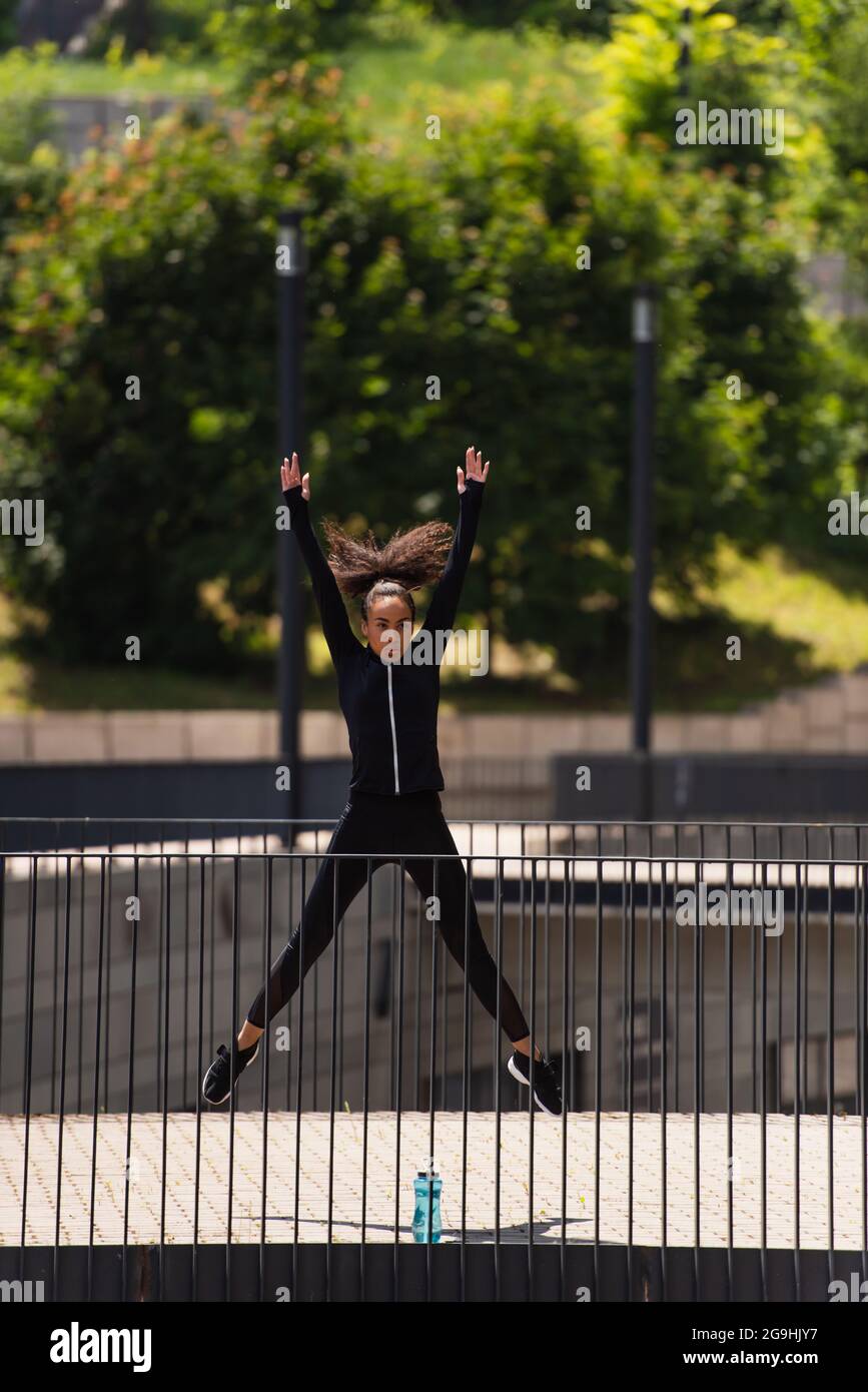 Unrecognizable Sportswoman Jumping Rope On A Bridge Stock Photo