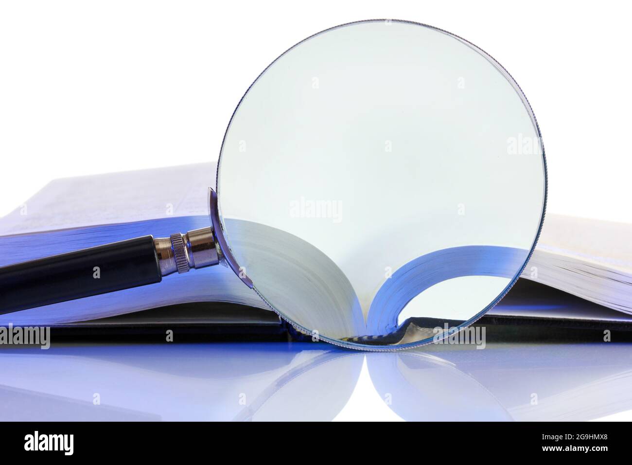 Magnifying glass and open book isolated on white Stock Photo - Alamy