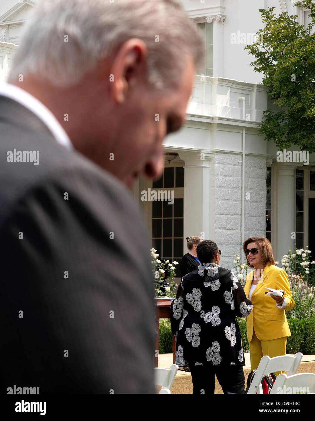 Speaker of the House Nancy Pelosi, a Democrat from California, right, speaks to Marcia Fudge, U.S. Secretary of Housing and Urban Development (HUD), as House Minority Leader Kevin McCarthy, a Republican from California, left, speaks to members of the media in the Rose Garden of the White House in Washington, DC, U.S., on Monday, July 26, 2021. The Biden administration is keeping foreign travel restrictions in place amid concern about rising Covid-19 case levels as the delta variant spreads. Photographer: Stefani Reynolds/Pool/Sipa USA Stock Photo