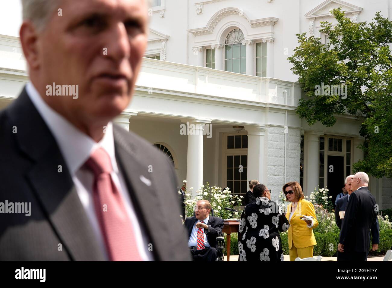 Speaker of the House Nancy Pelosi, a Democrat from California, center, speaks to Marcia Fudge, U.S. Secretary of Housing and Urban Development (HUD), as House Minority Leader Kevin McCarthy, a Republican from California, left, speaks to members of the media in the Rose Garden of the White House in Washington, DC, U.S., on Monday, July 26, 2021. The Biden administration is keeping foreign travel restrictions in place amid concern about rising Covid-19 case levels as the delta variant spreads. Photographer: Stefani Reynolds/Pool/Sipa USA Stock Photo