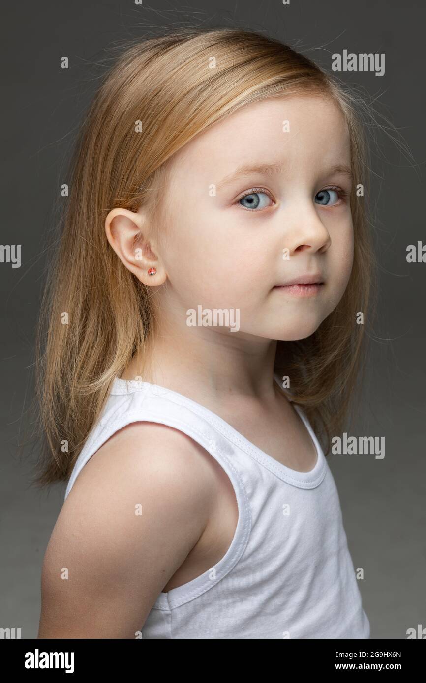 Cute little girl in white undershirt standing alone Stock Photo Alamy