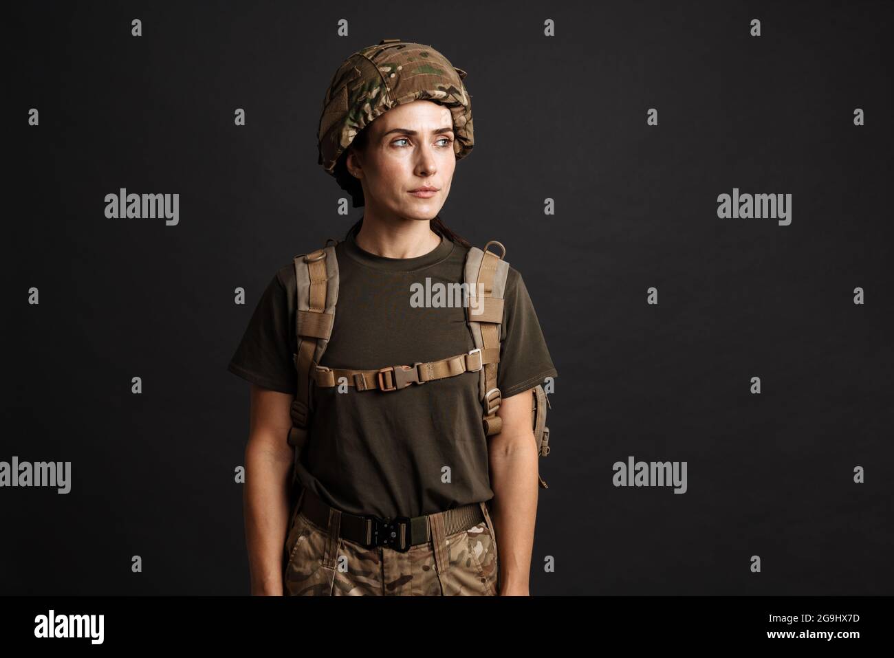 young woman wearing tank top, military style khaki pants and boots