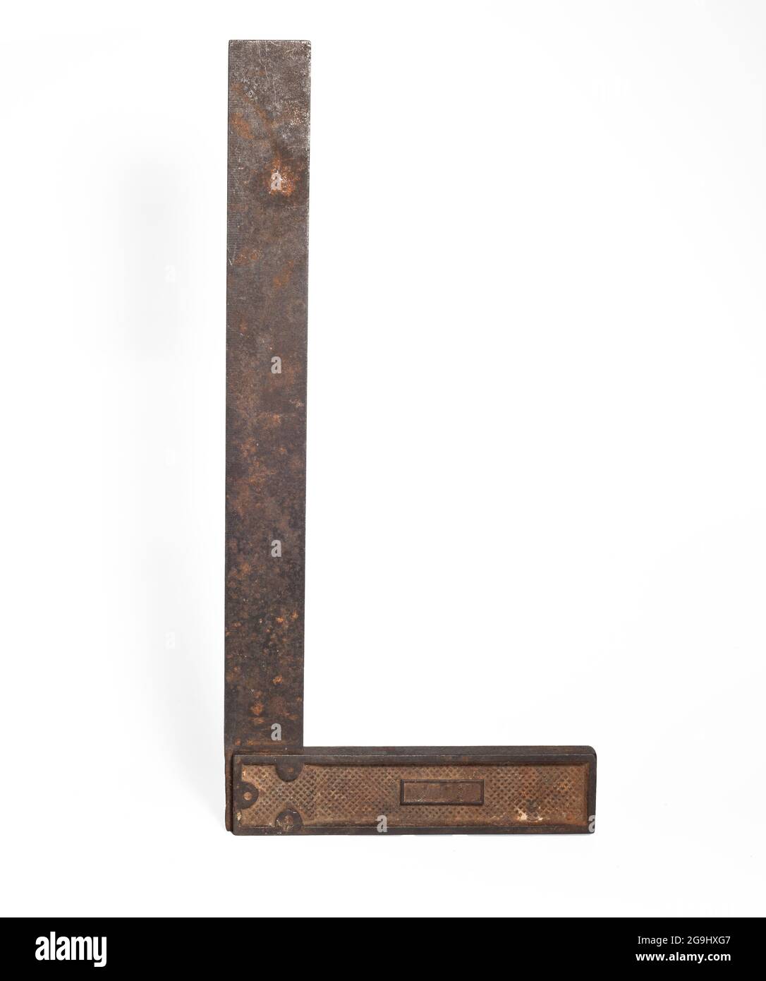 vintage machinist layout square tool over white. an old metal corner