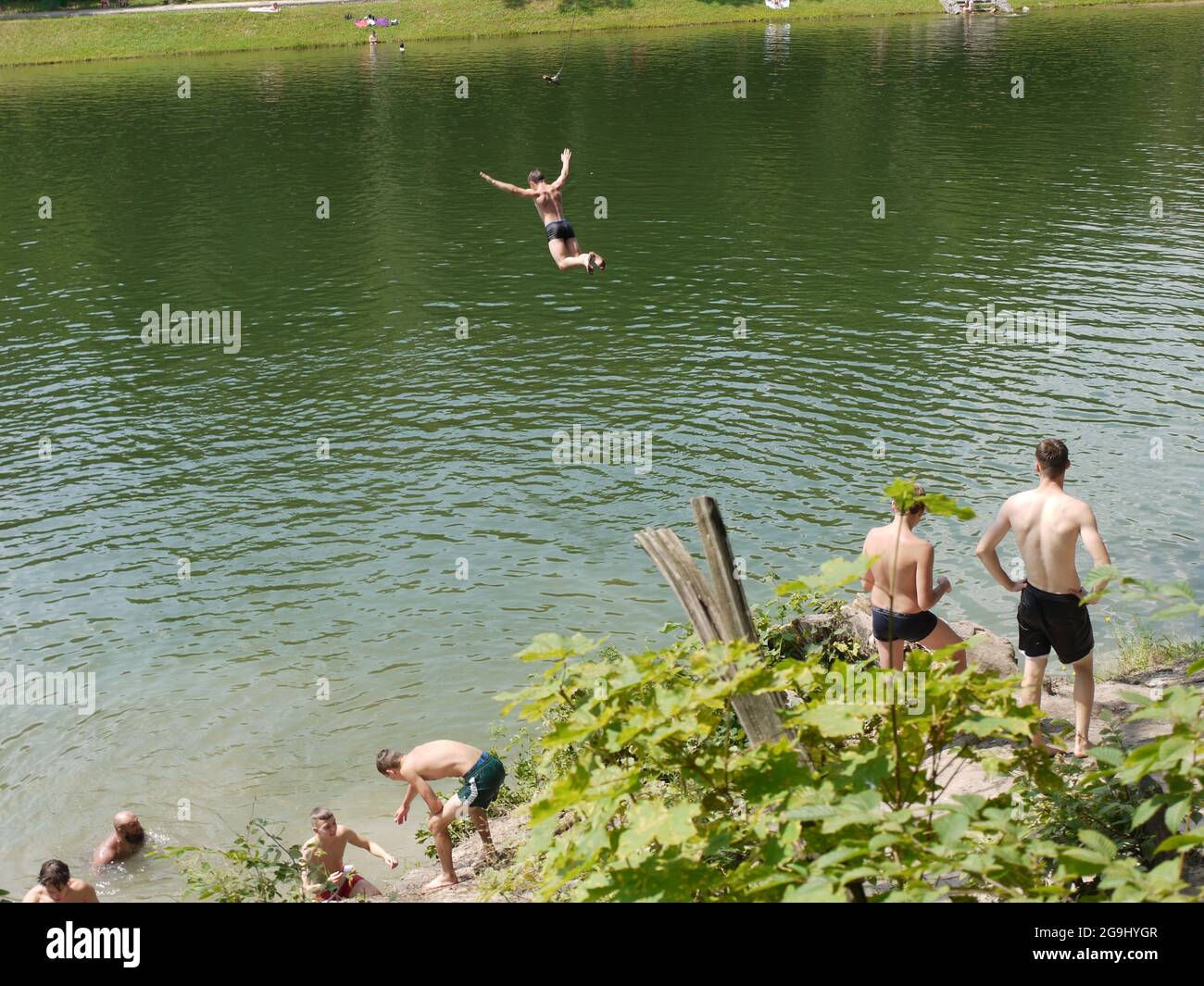 A man flying while swimming in one of the lakes in Kiev, Ukraine Stock Photo
