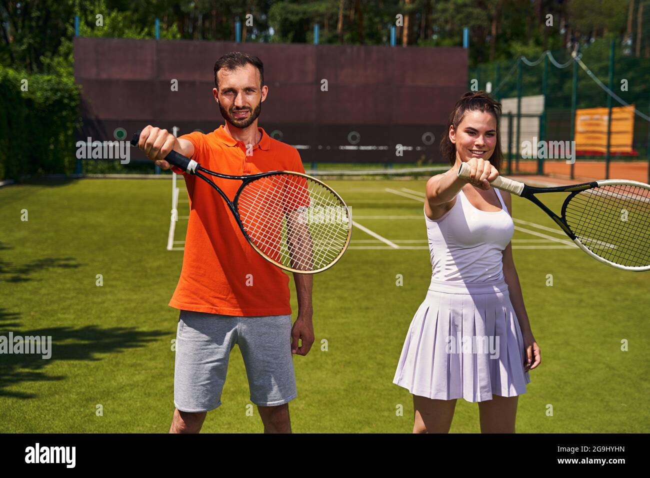 Two tennis players practicing a correct grip technique Stock Photo