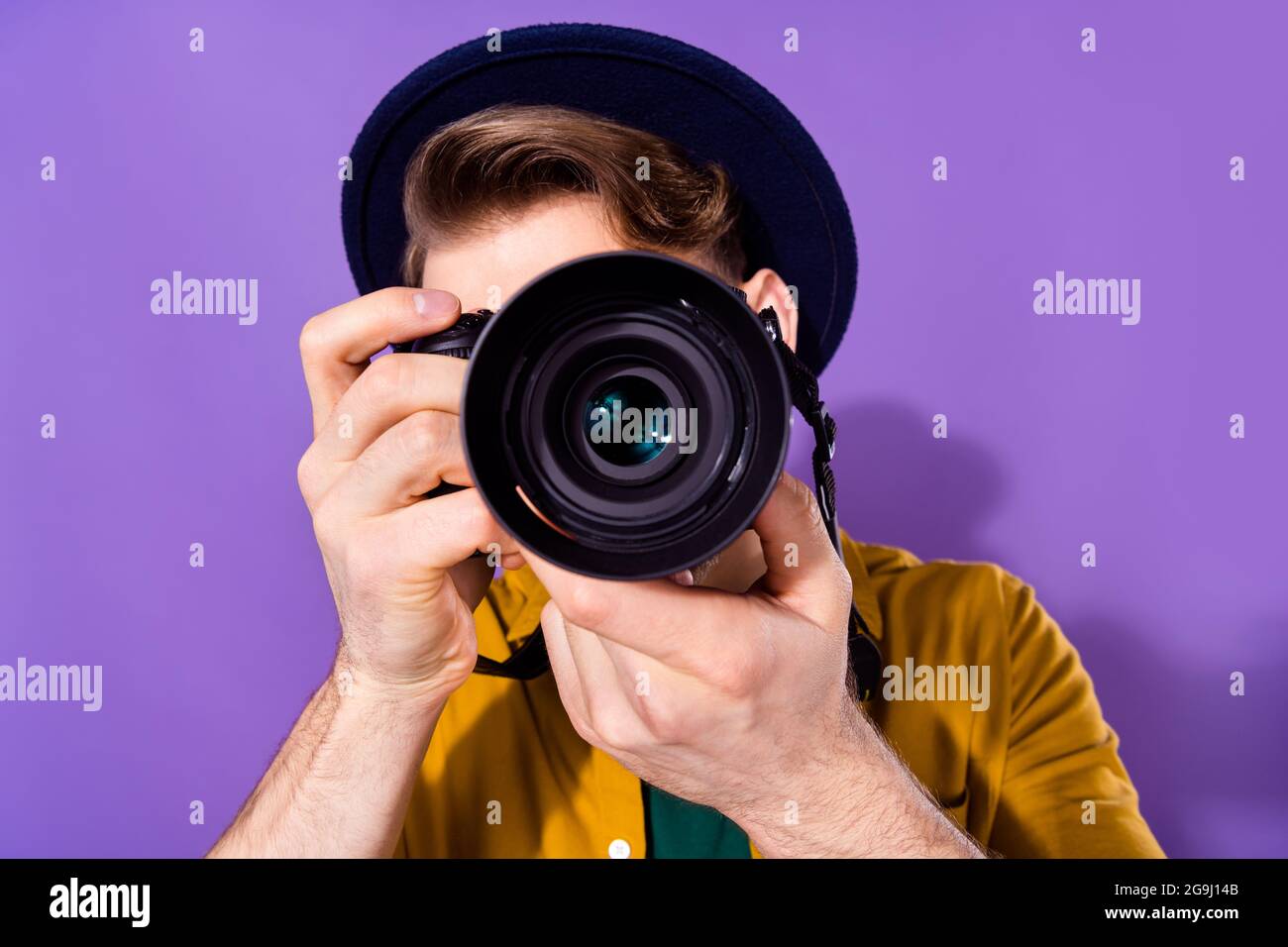 Portrait of nice skilled guy holding using cam shooting you travel tour isolated over bright violet purple color background Stock Photo