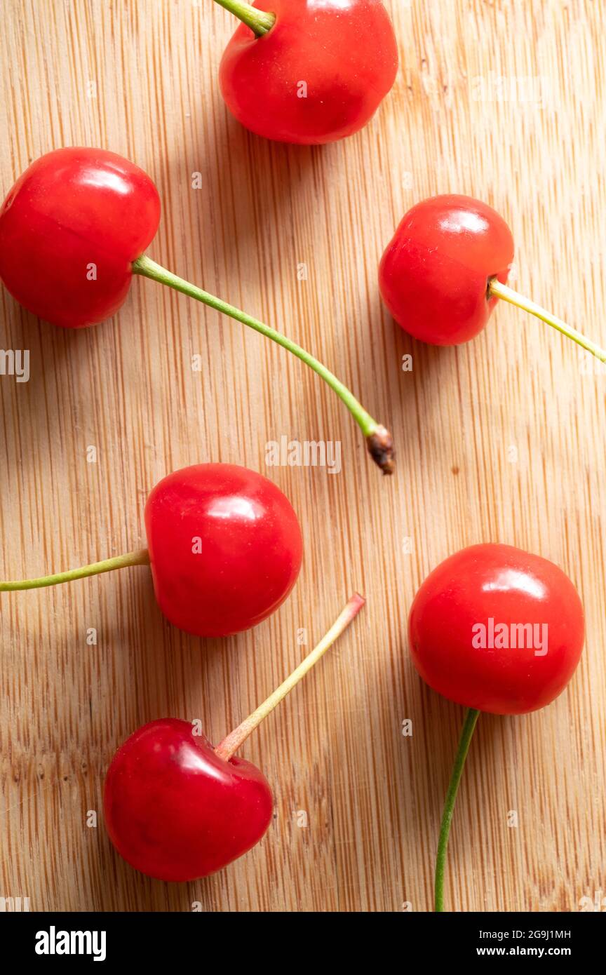 Top View of Red Cherries on a Wood Table Stock Photo