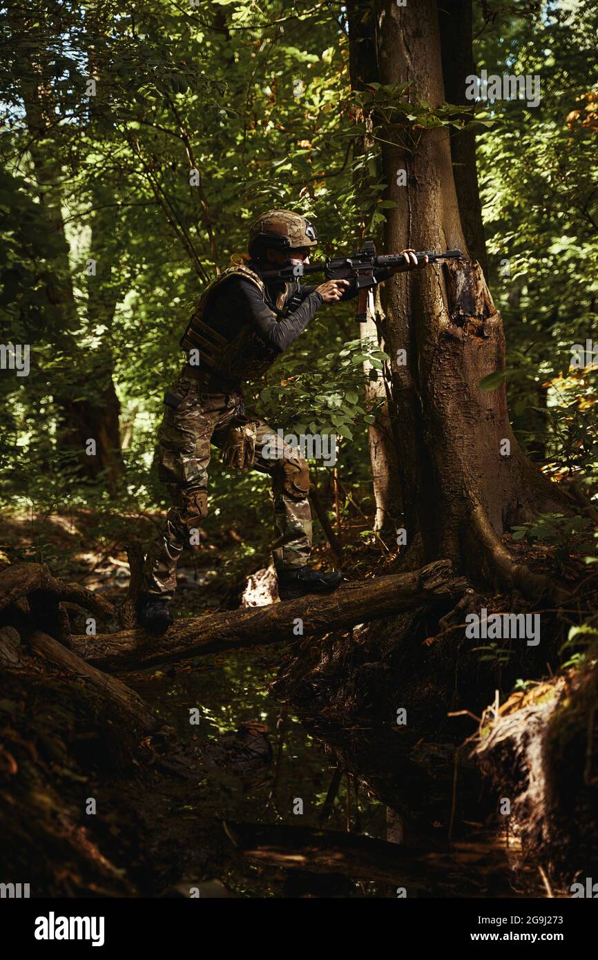 Female person in dangerous military conditions of war Stock Photo