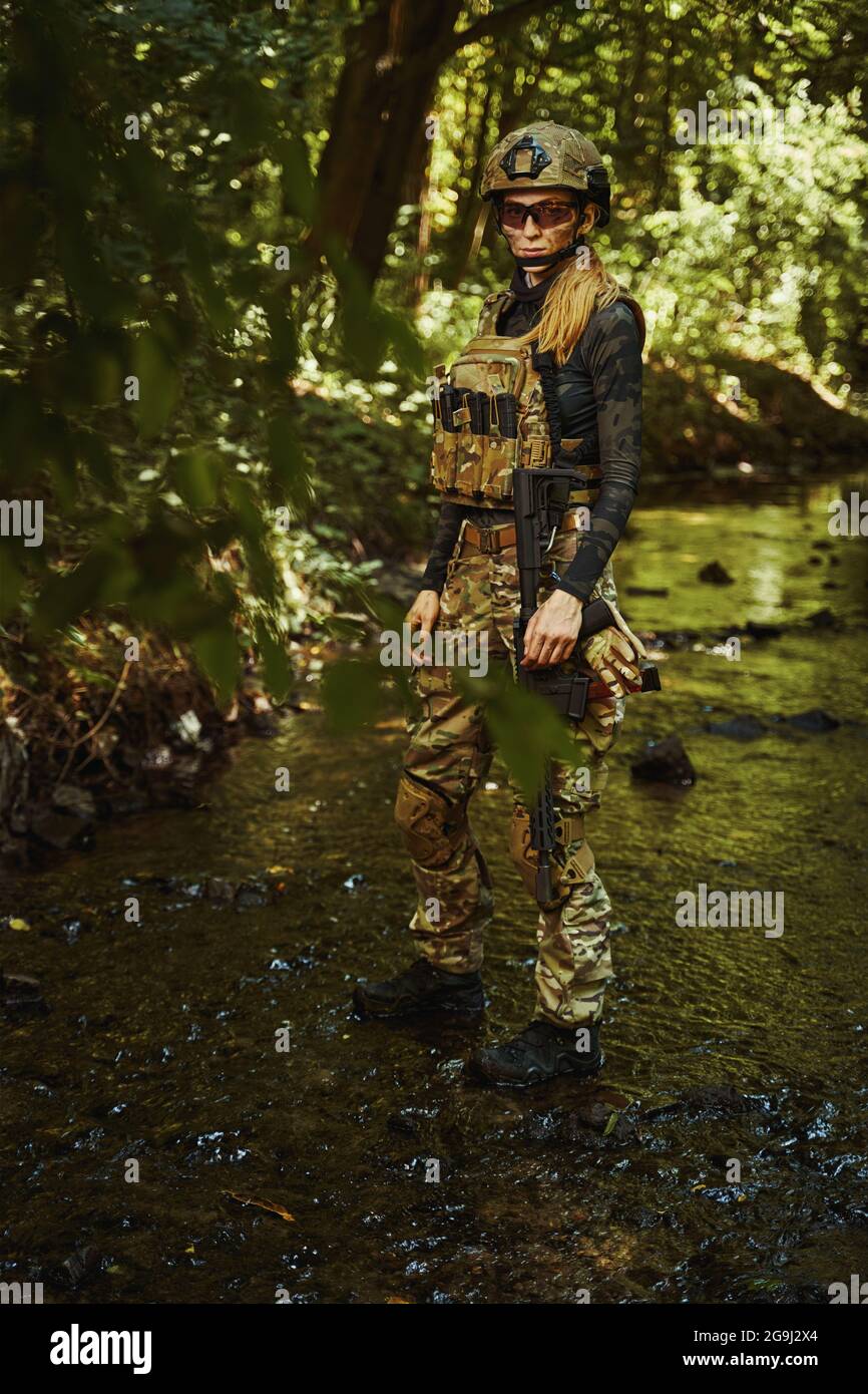 Soldier in camouflage grouping walking through reservoir Stock Photo ...