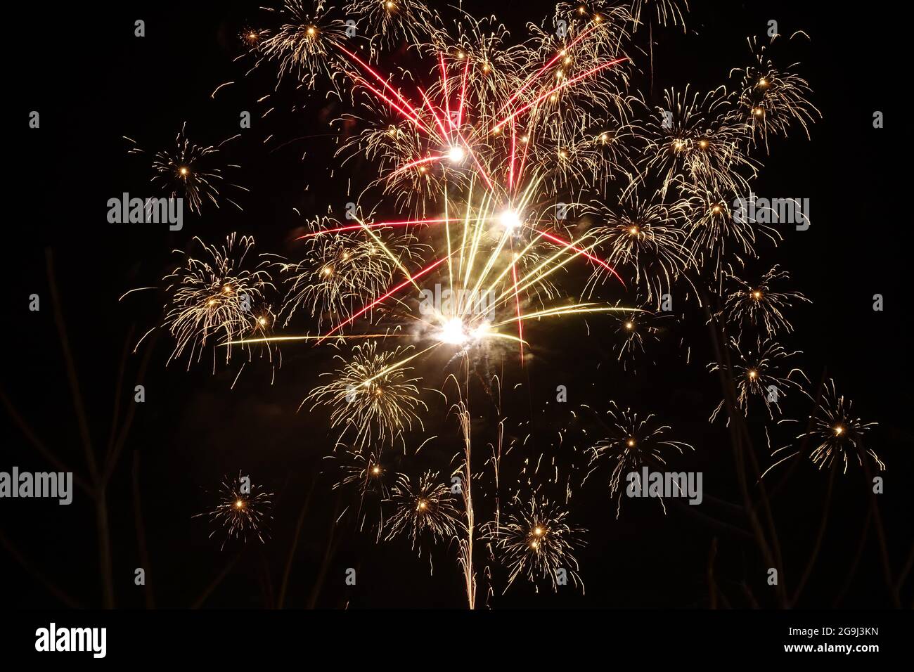 3d rendering of many small colorful, fireworks on a black background ...
