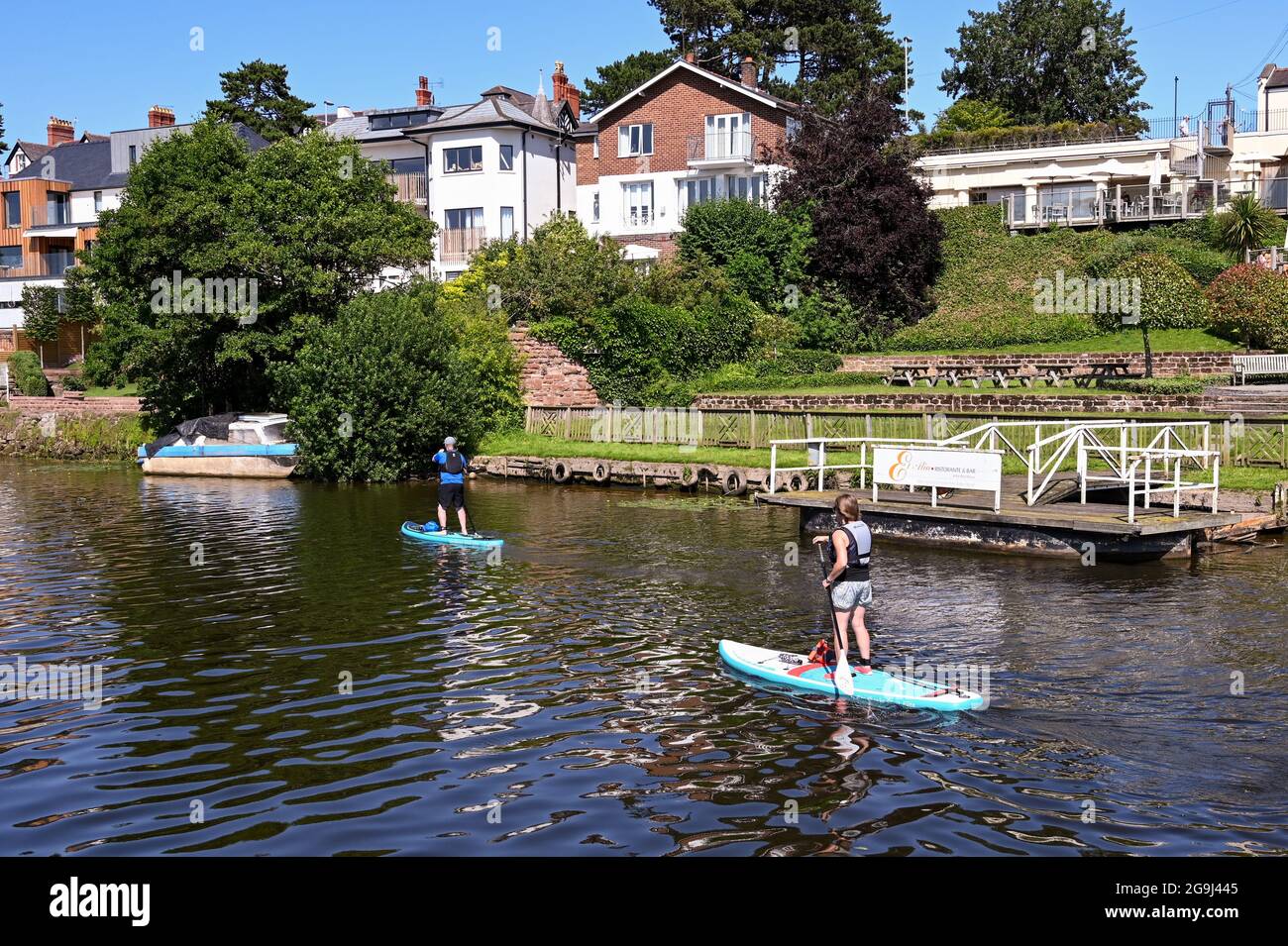 Chester, Cheshire, England July 2021 Two people paddle boarding