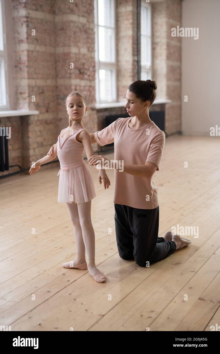 Little girl learning to stand in right position during her ballet