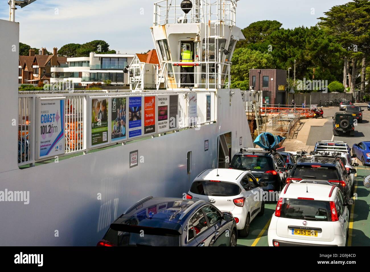 Poole, Dorset, England - June 2021: Cars waiting to drive off the chain ferry which crosses the mouth of Poole harbour joining Poole with Swanage Stock Photo