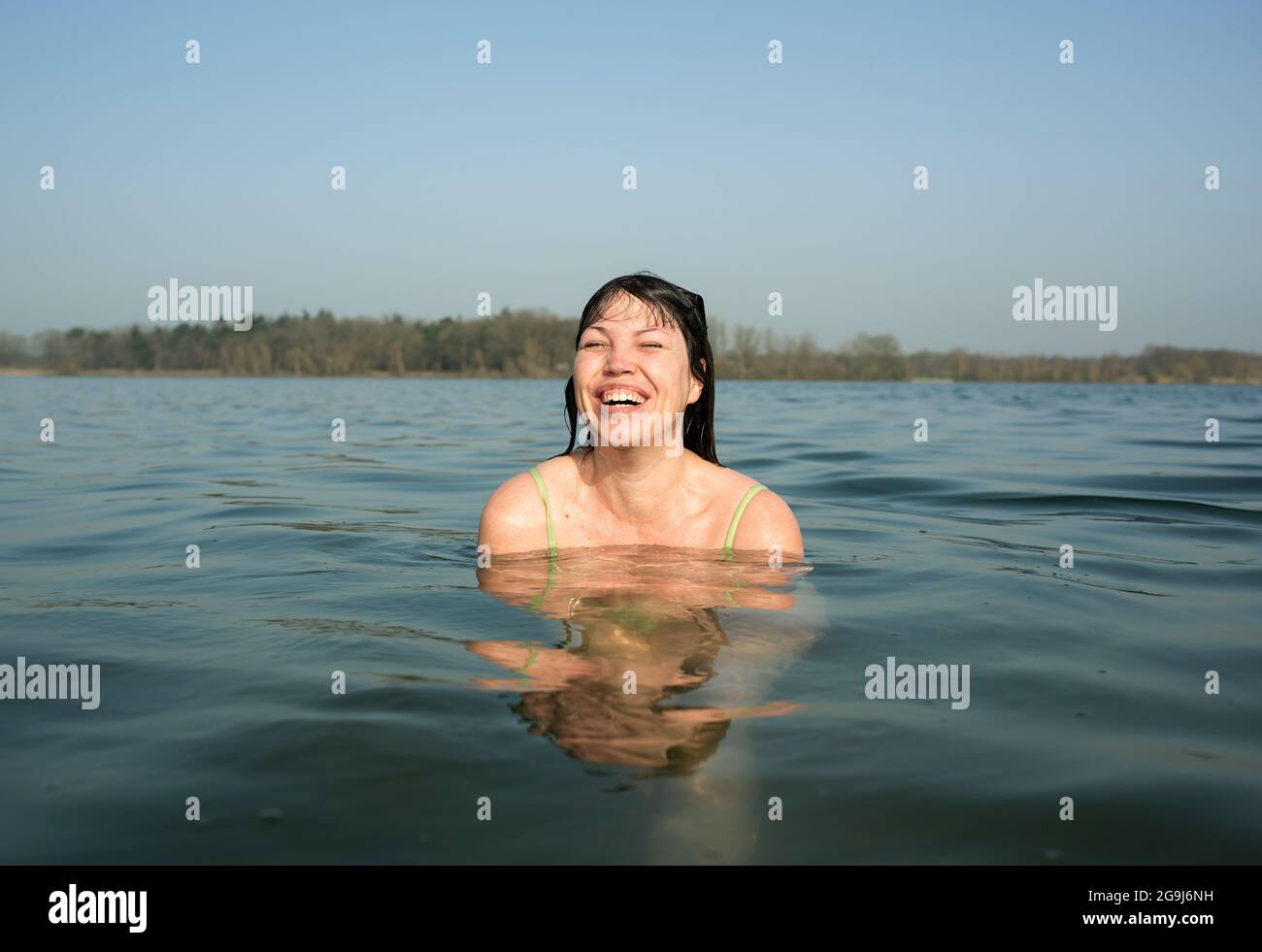 Netherlands, Noord-Brabant, Breda, Woman laughing in lake Stock Photo