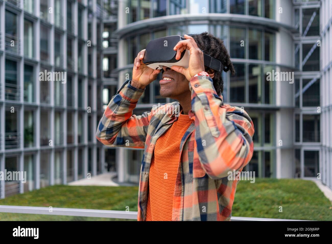 Germany, Berlin, Man using virtual reality goggles in city Stock Photo