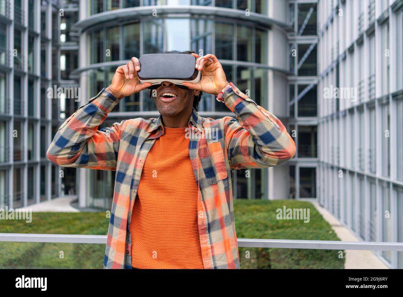 Germany, Berlin, Man using virtual reality goggles in city Stock Photo