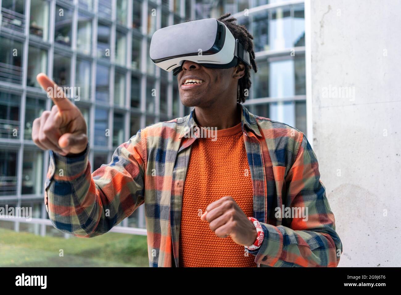 Germany, Berlin, Man using virtual reality goggles in city Stock Photo