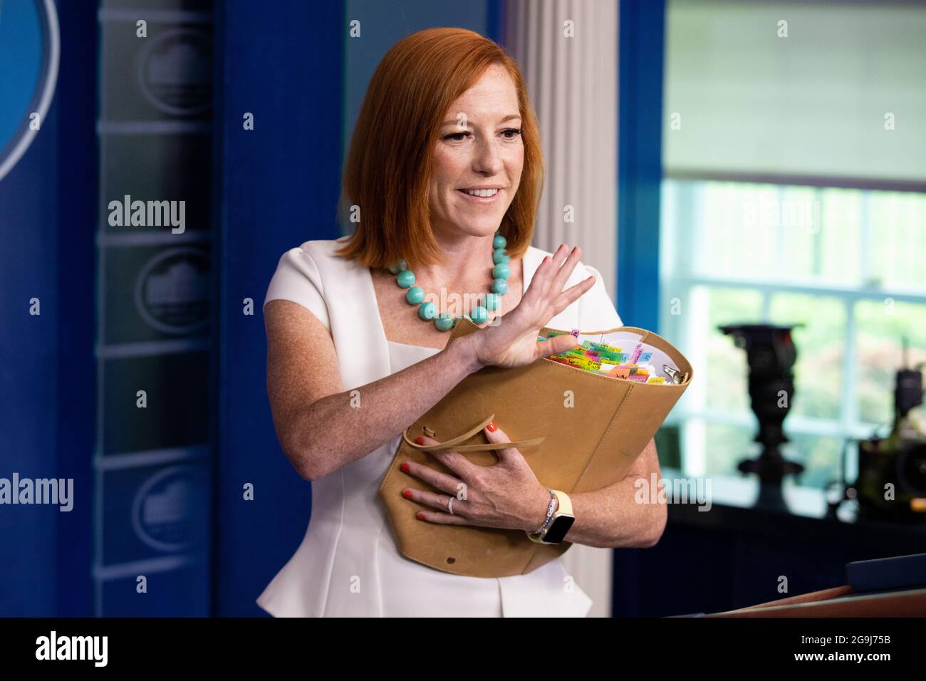 White House Press Secretary Jen Psaki waves goodbye to members of the ...