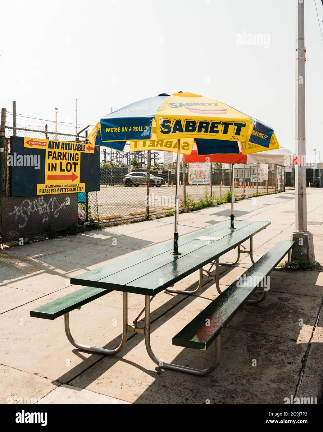 Picnic table with Sabrett umbrella, in Coney Island, Brooklyn, New York