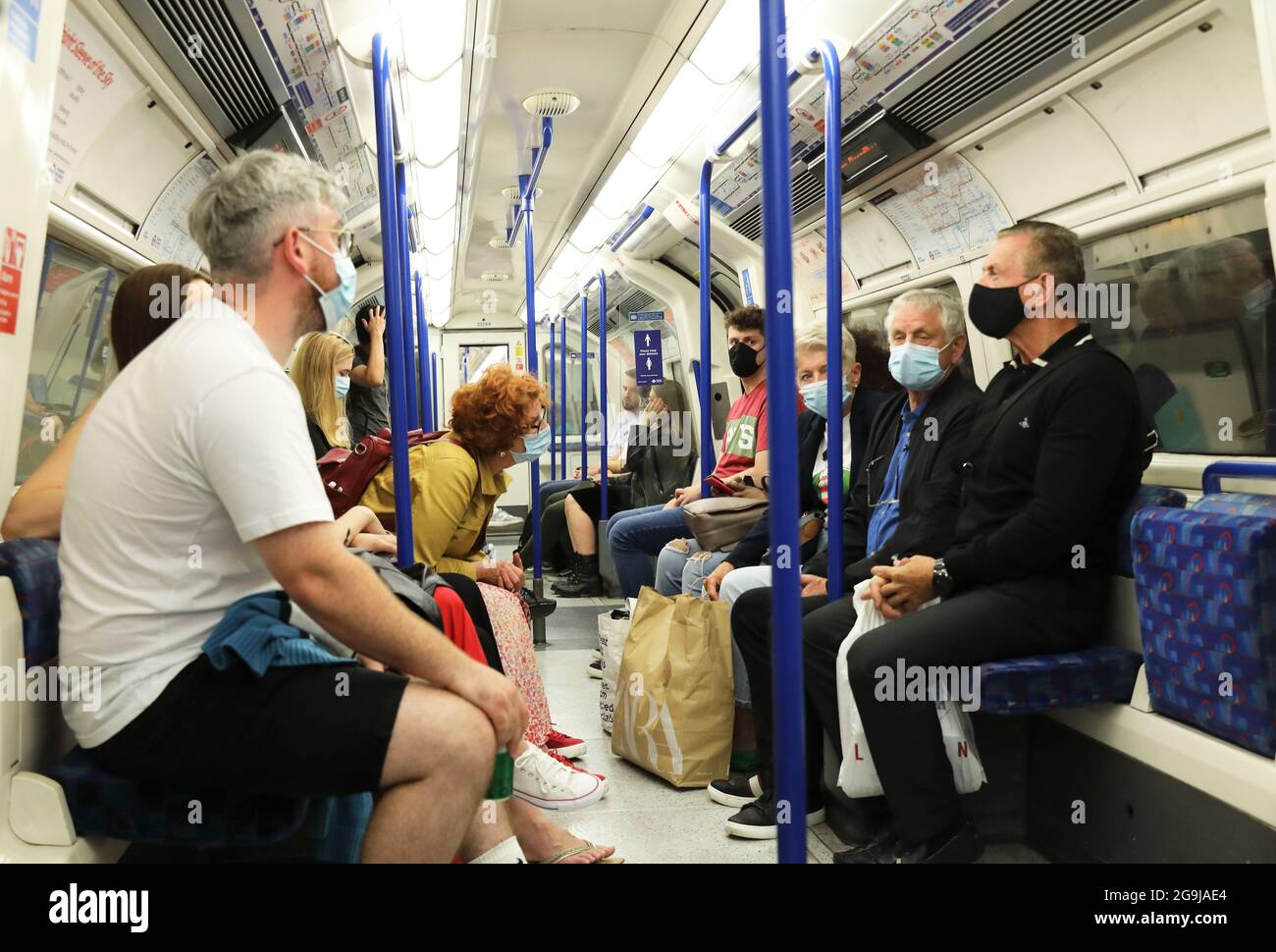 Passengers wearing face masks on the tube in London, UK Stock Photo Alamy