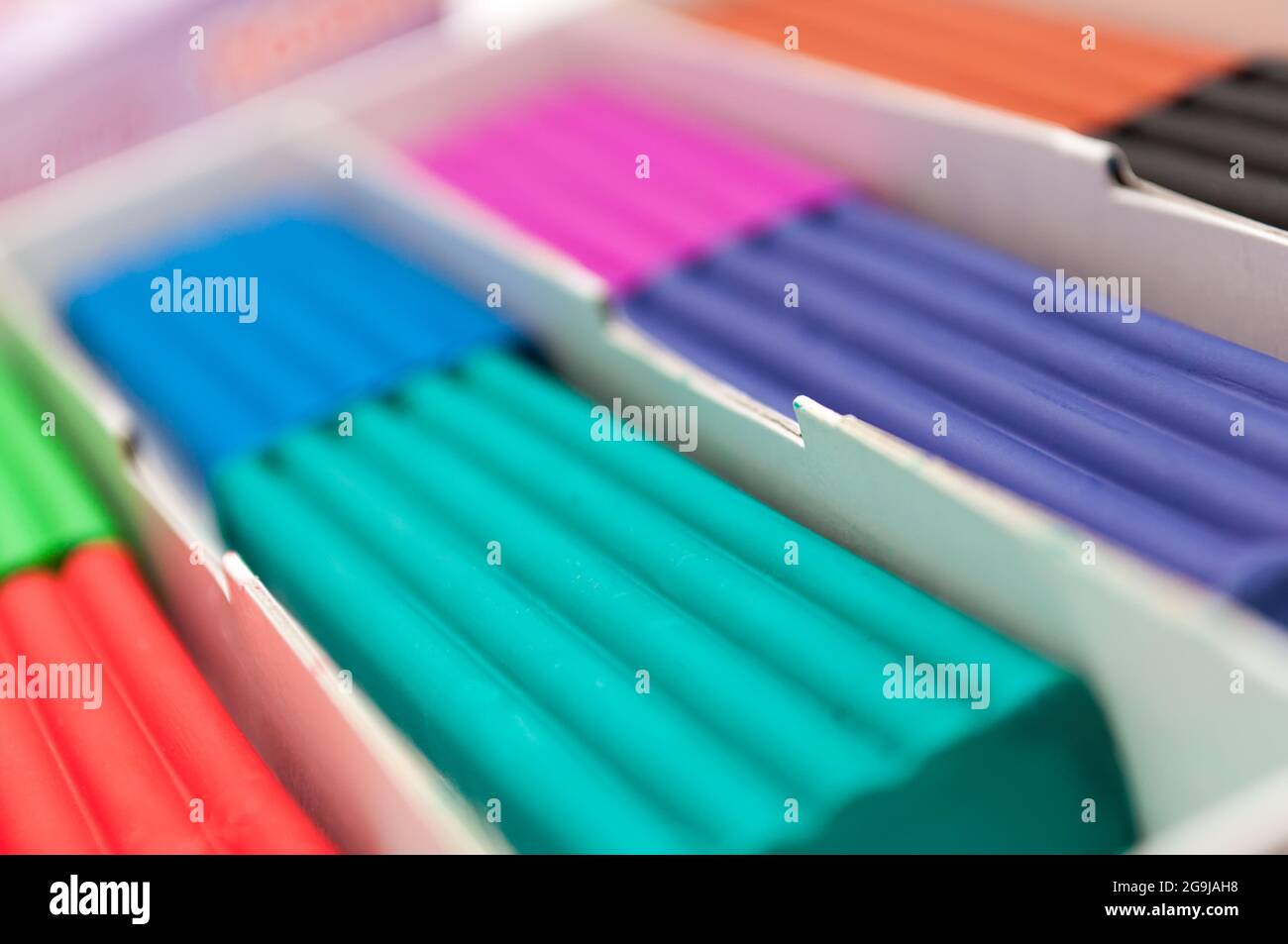 Box with children's colorful plasticine. blurred Background Stock Photo