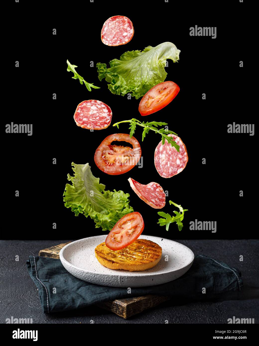 Creative concept with falling food on black backdrop Stock Photo