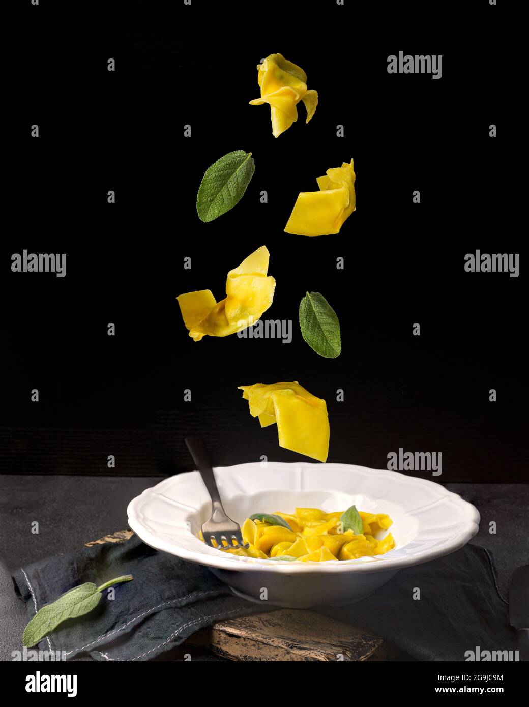 Creative concept with falling food on black backdrop Stock Photo