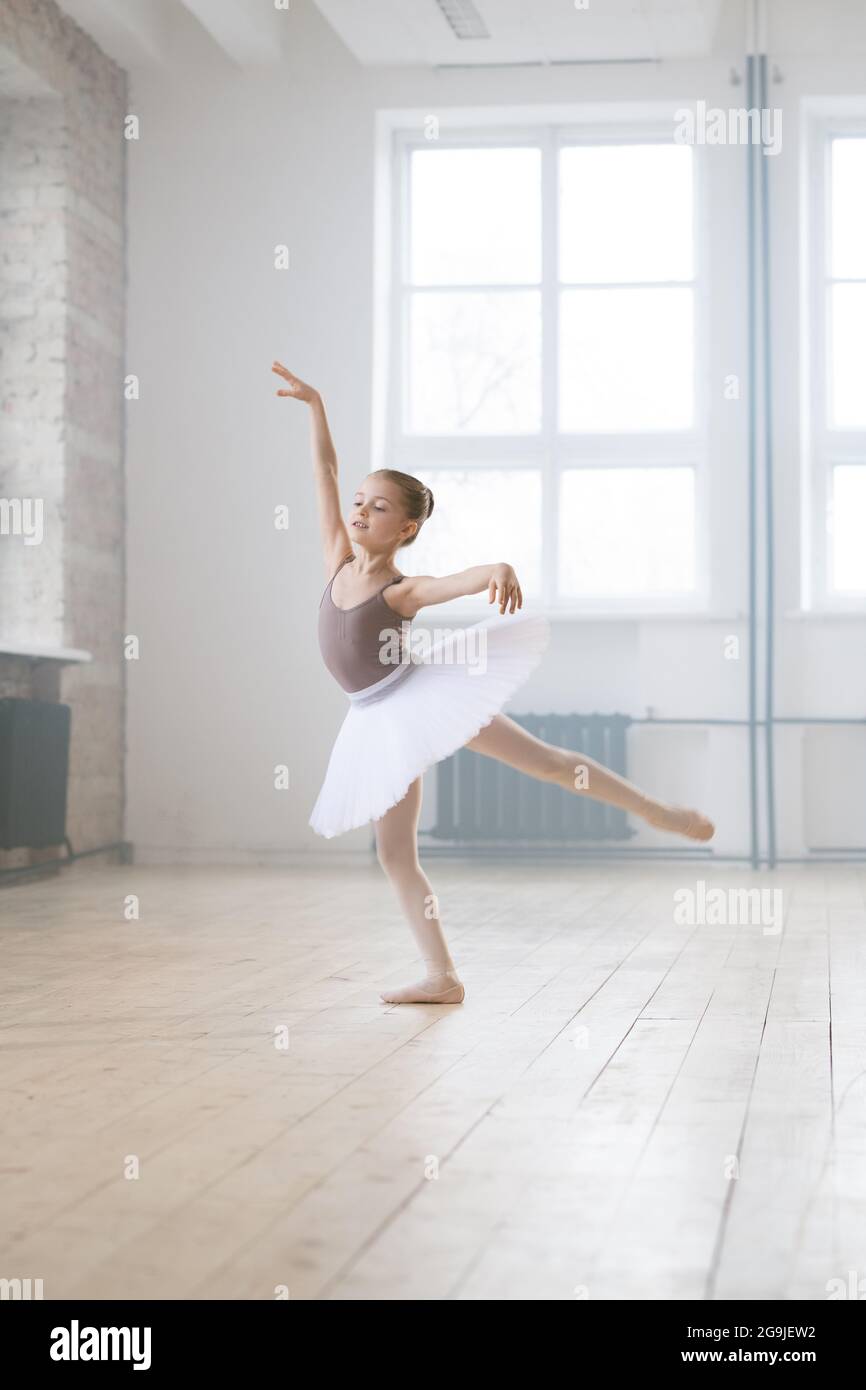 Little ballerina in tutu dress performing ballet dance alone in dance hall  Stock Photo - Alamy