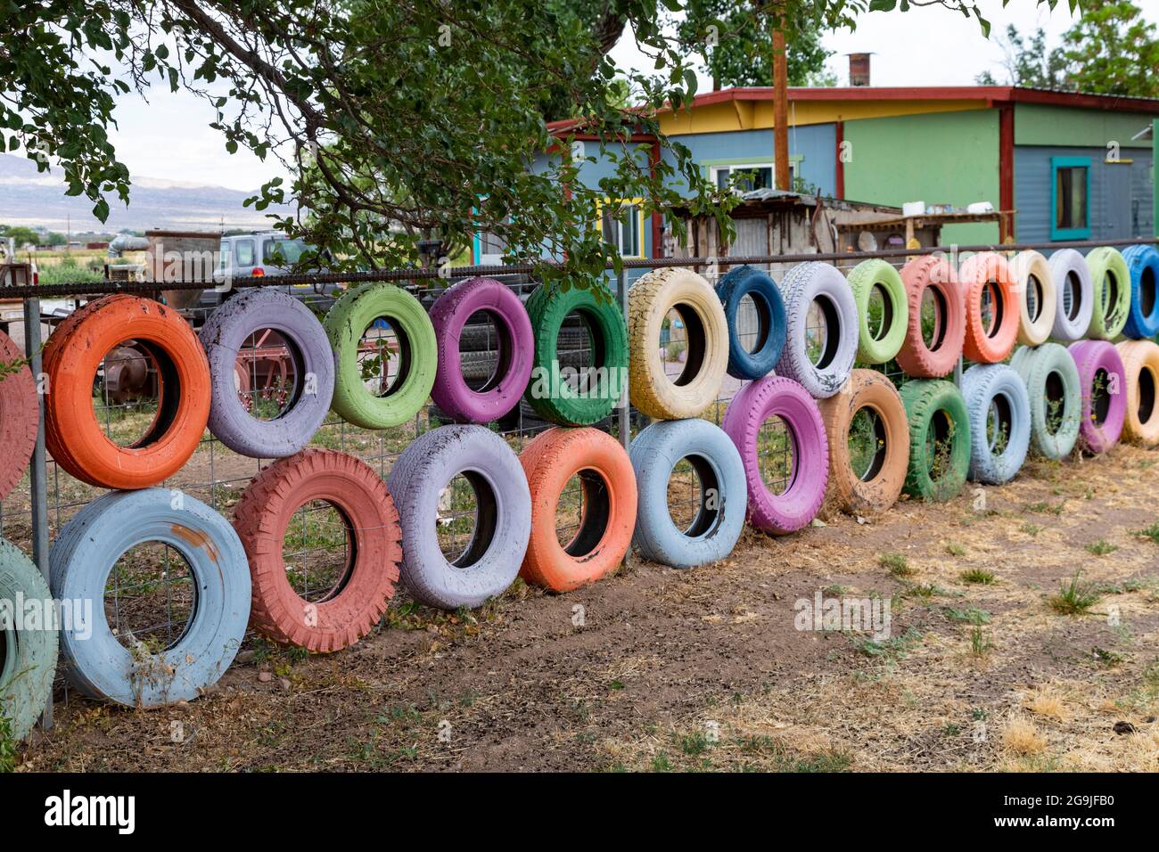 Escondida, New Mexico - Painted tires hung on a homeowner's fence in the New Mexico desert. Stock Photo