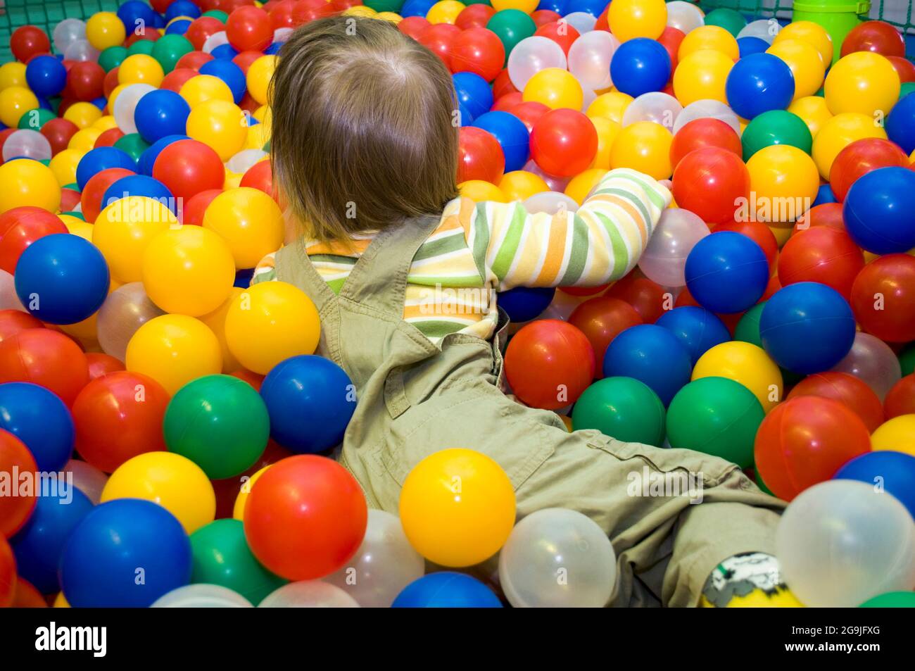 Baby girl in ball pit Stock Photo Alamy