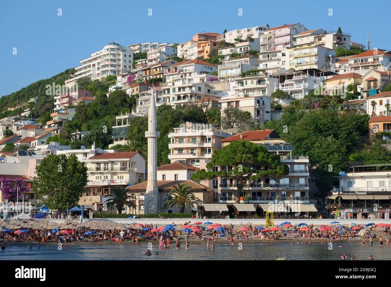 ULCINJ, MONTENEGRO - JULY 10, 2015: Ulcinj crowded beach 'Mala Plaza' with elegant minaret on the promenade, Montenegro Stock Photo