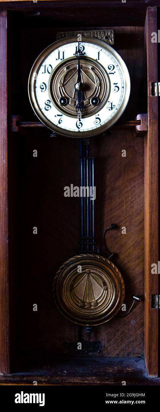 Fragment of antique wall clock with pendulum Stock Photo - Alamy