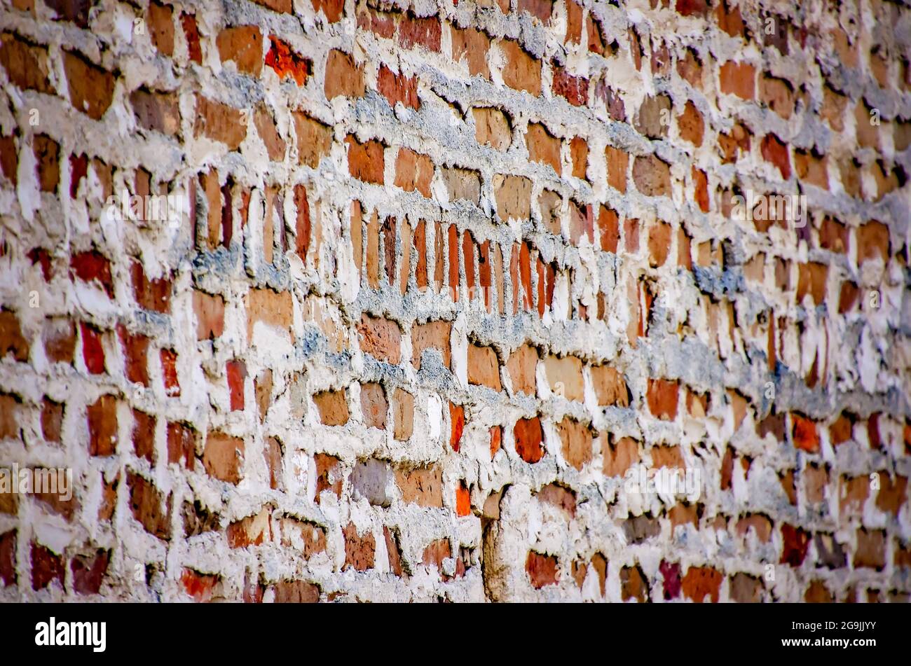 A historic brick wall shows messy mortar, also called weeping mortar, on July 23, 2021, in Mobile, Alabama. Stock Photo