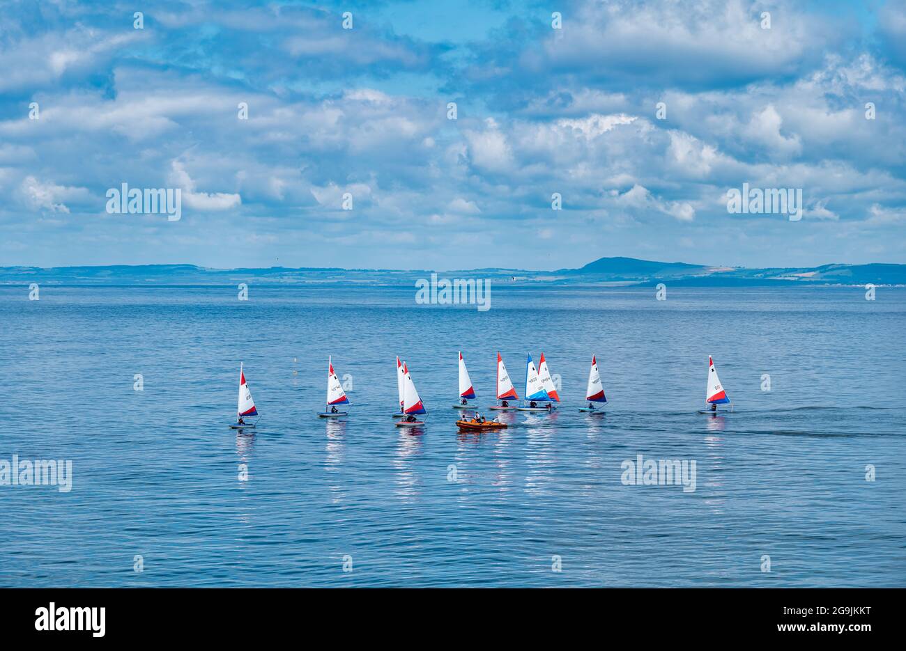 Sailing dinghies in the Firth of Forth on a hot sunny Summer day with blue sky and clouds, Scotland, UK Stock Photo
