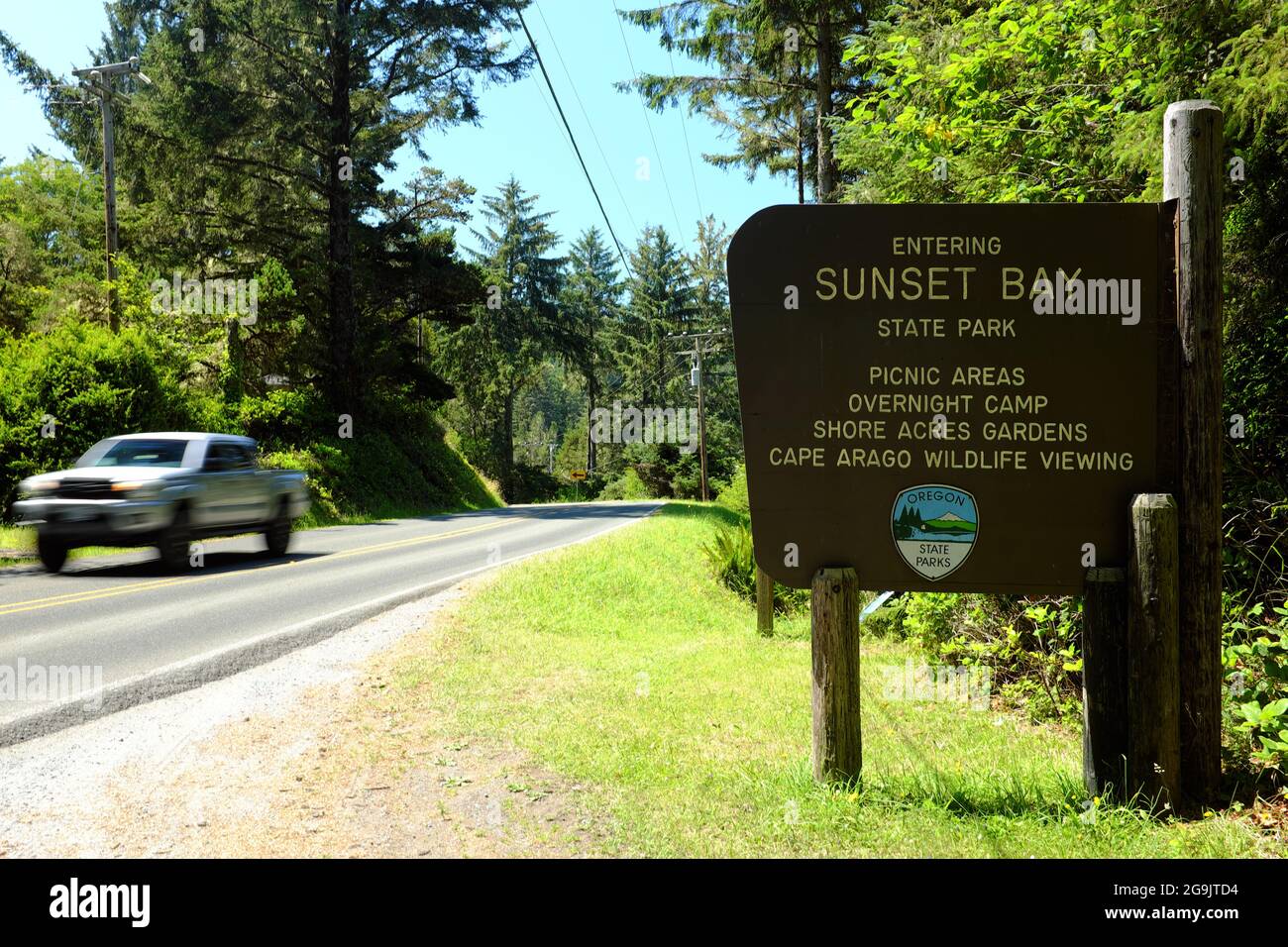 A vehicle on the Cape Arago Highway at the entrance to Sunset Bay State Park near Coos Bay, Oregon. Stock Photo