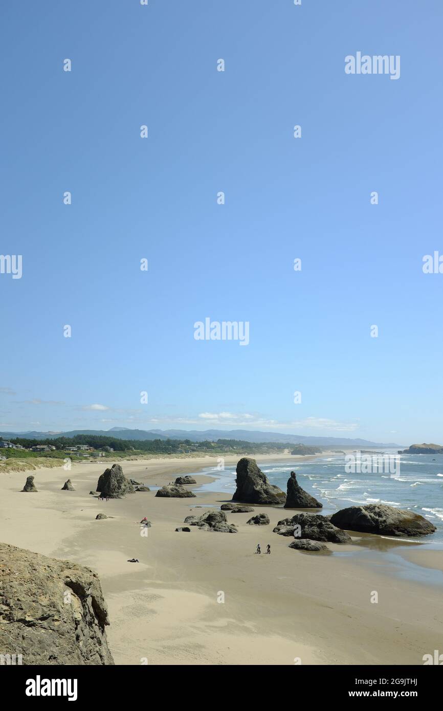 People enjoying the beach as seen from Face Rock State Scenic Viewpoint in Bandon, Oregon. Stock Photo