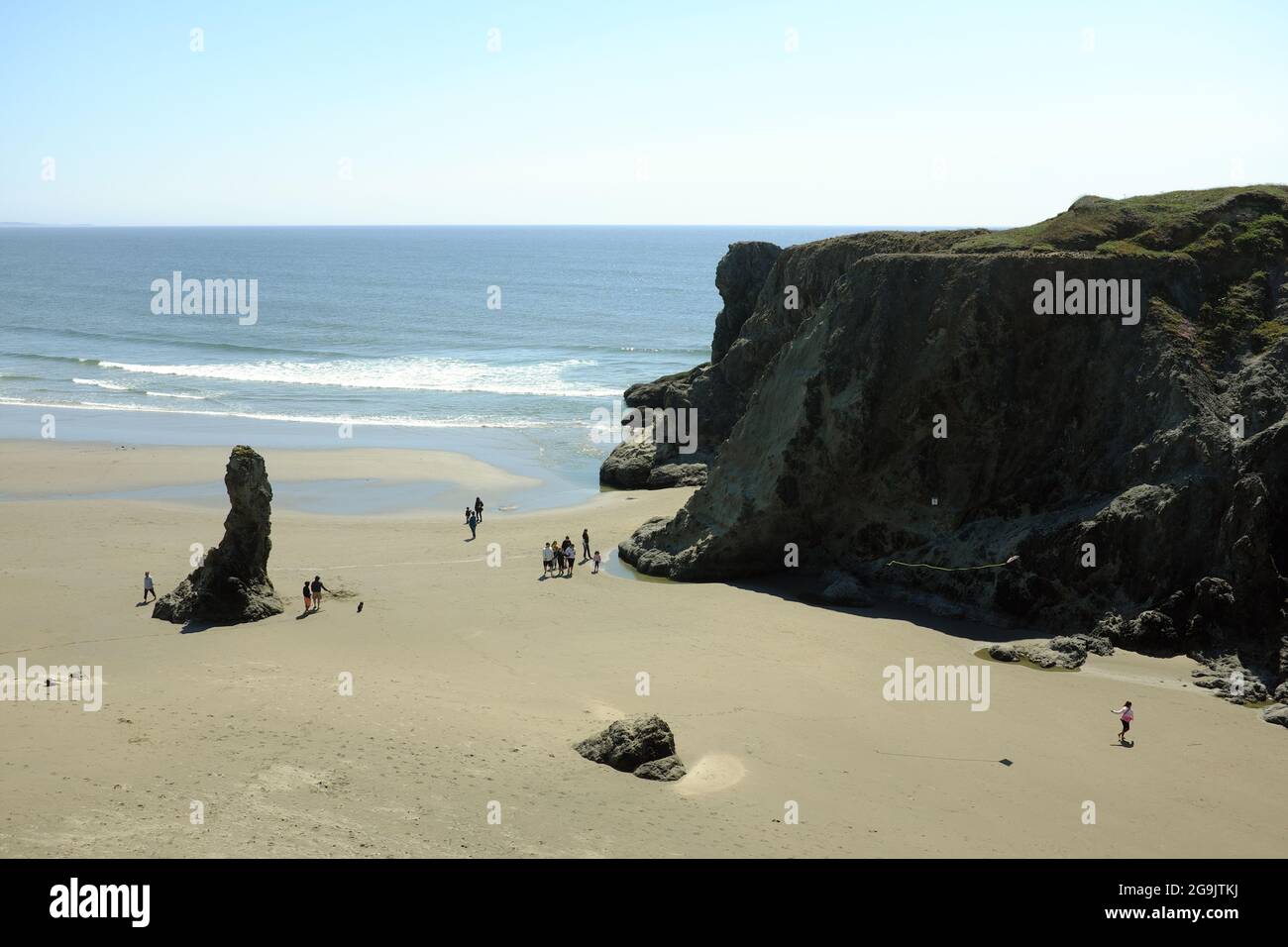 People enjoying the beach as seen from Face Rock State Scenic Viewpoint in Bandon, Oregon. Stock Photo