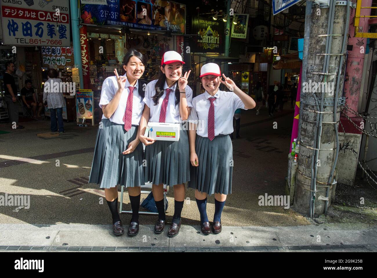 Friendly school girls, Business district, Naha, Okinawa, Japan Stock Photo