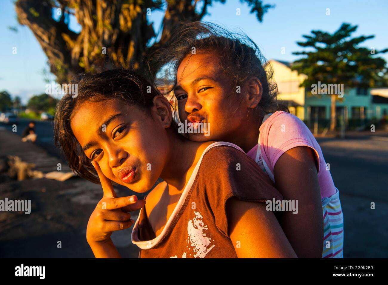 Young girls posing as western actors, Apia, Upolo, Samoa, South Pacific Stock Photo
