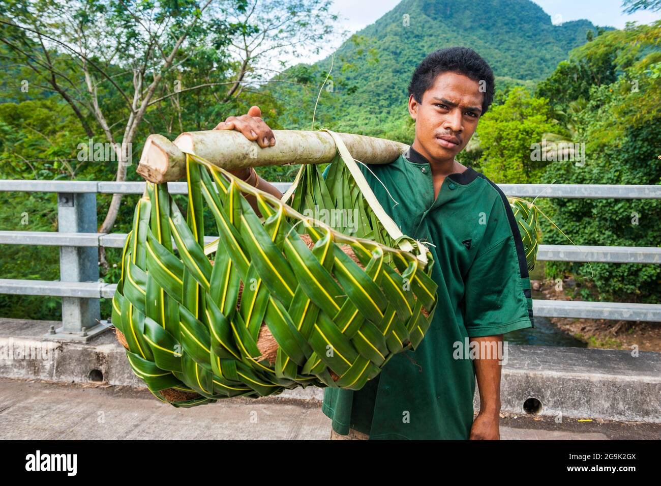 Local farmer bringing his goods in palm baskets back home, Upolo, Samoa, South Pacific Stock Photo