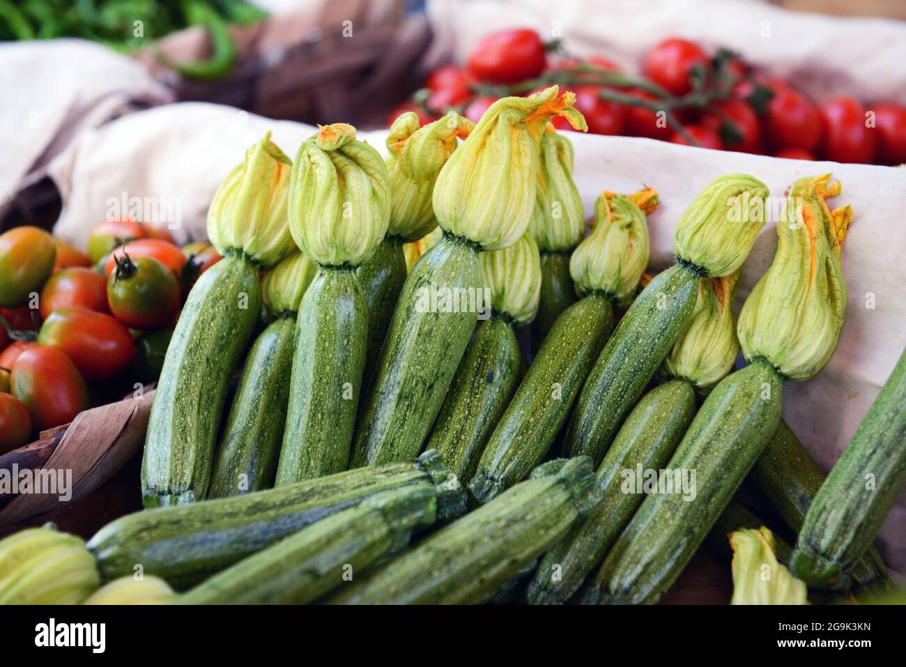 Zucchini with the flowers displayed by a vendor at the Mercatino Antignano in Naples, Italy. Stock Photo