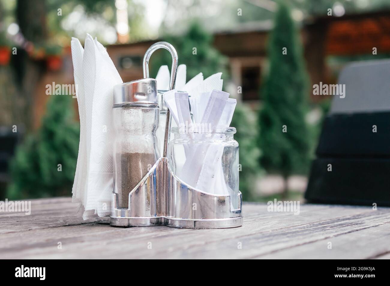 Napkins, pepper and toothpicks in metal coaster. Stock Photo