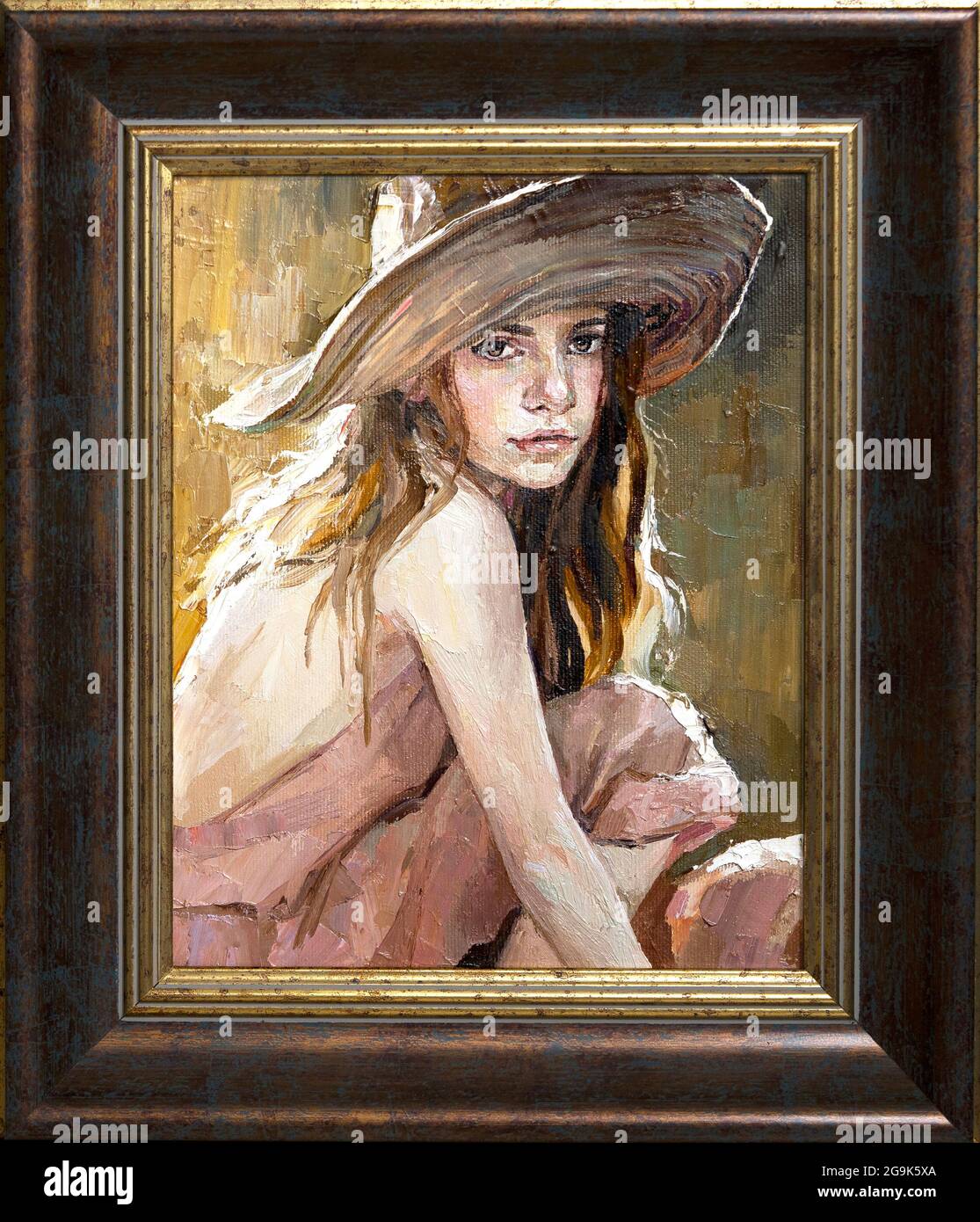 .A woman in a straw hat sits in the sunset Stock Photo - Alamy
