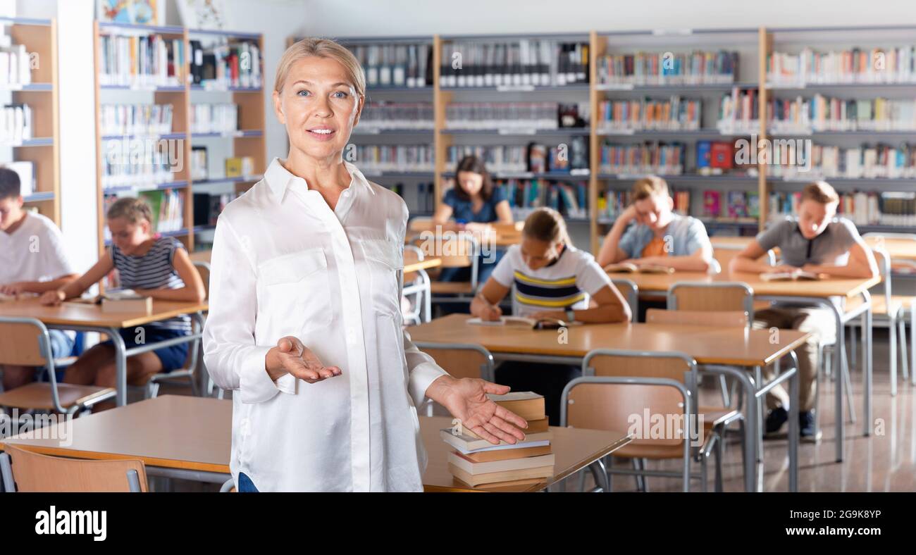 Portrait of mature woman teacher standing in classroom Stock Photo - Alamy
